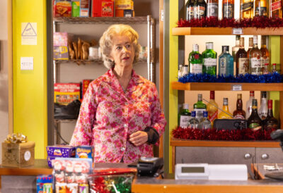 Evelyn looks worried in the shop on Corrie