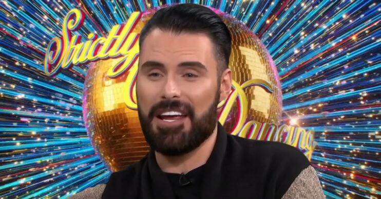 Rylan Clark in front of Strictly logo