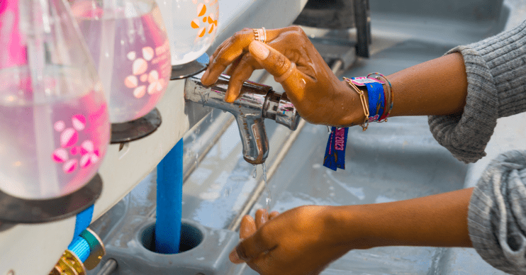 Person washing their hands at a festival