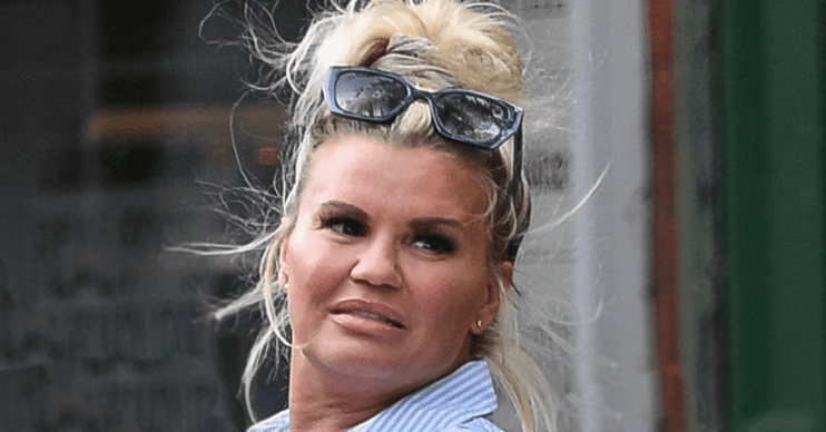 Kerry Katona with her hair up wearing sunglasses on her head